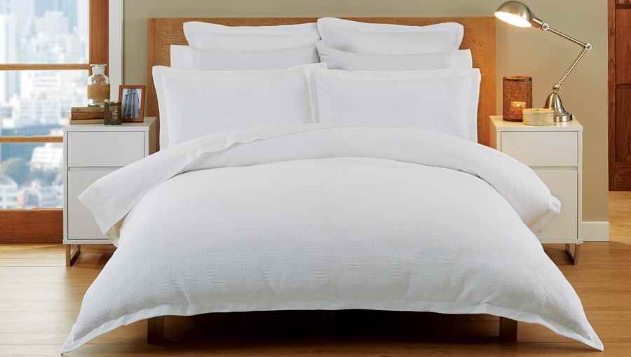 luxurious bed with pillows, sheets and blankets